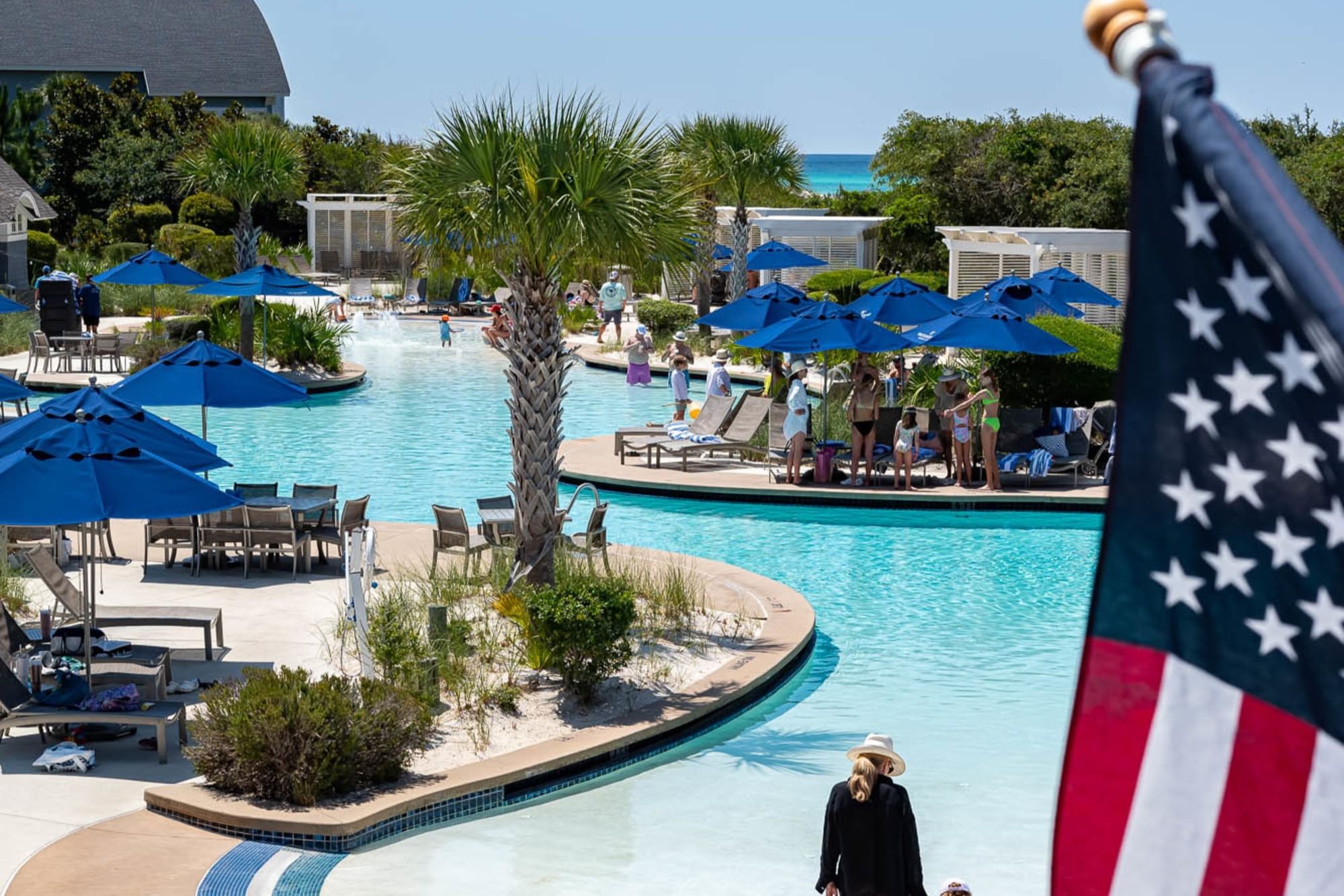 An American Flag waves over one of the Watersound Beach Club pools on a sunny day