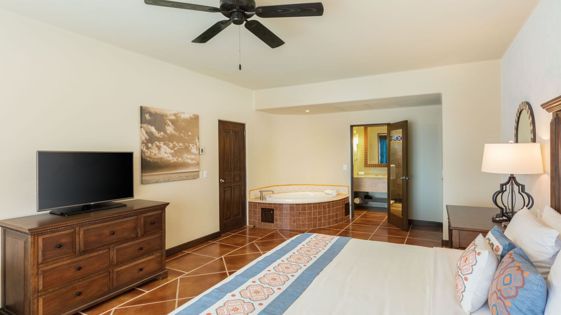 Bedroom with king bed, flat screen TV and in-room jacuzzi inside the Two Bedroom Villa at Hacienda Del Mar Los Cabos.