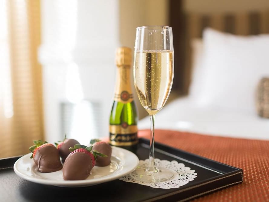 Champagne and chocolate covered strawberries on a tray at Pickwick San Francisco.