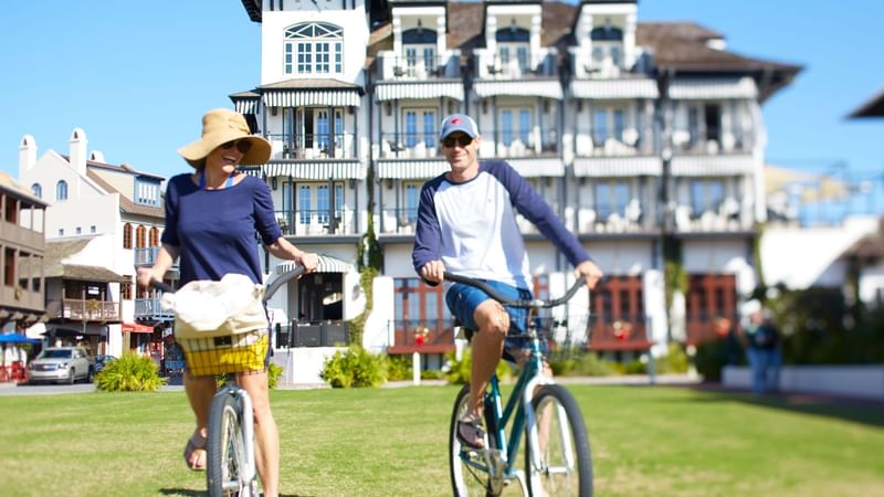 Couple riding bikes in front of The Pearl Hotel