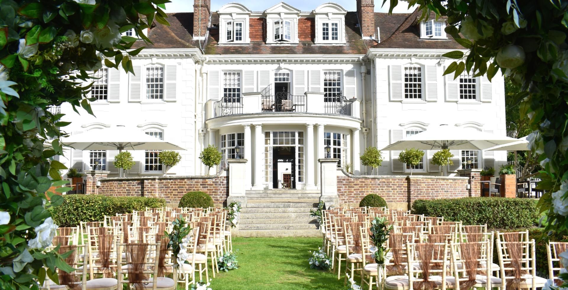 Outdoor wedding ceremony in the gardens at Gorse Hill in Surrey