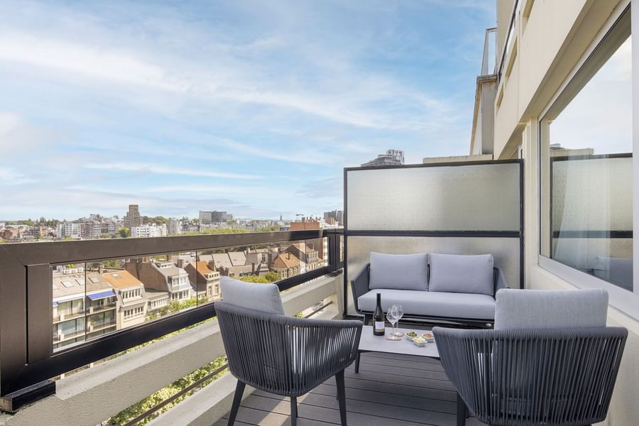 Outdoor sofa by a coffee table in grey colour under an open sky in Warwick Suite with terrace at Hotel Barsey by Warwick