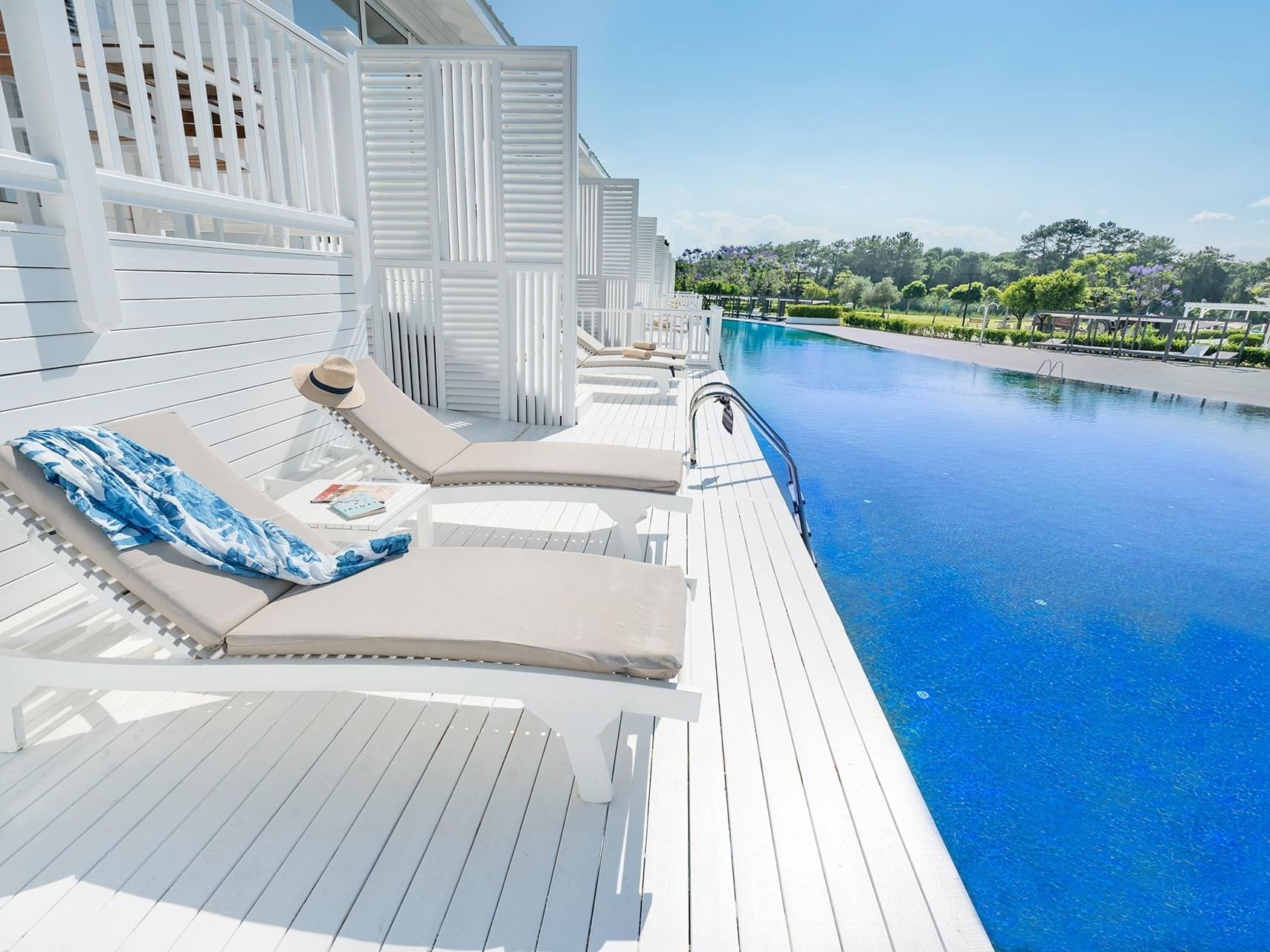 Outdoor pool area and sun lounges in Maldive House at Titanic Deluxe Golf Belek