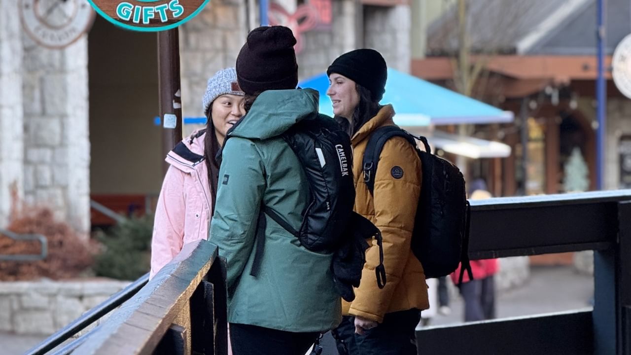 Three girls dressed for winter in Whistler Village