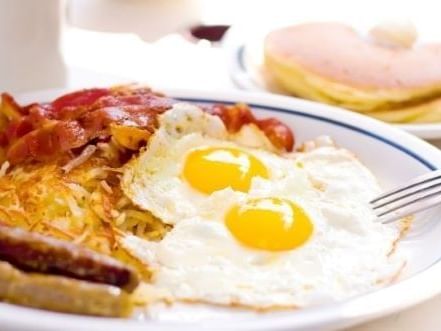 Eggs, sausage, and crispy bacon served at Hotel St. Pierre