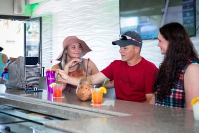 a group of people drinking cocktails at a bar