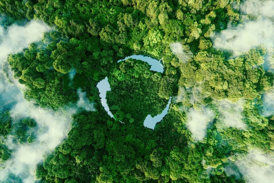 Aerial view image with a view of lush forest and river forming a recycling symbol at Warwick Corporate