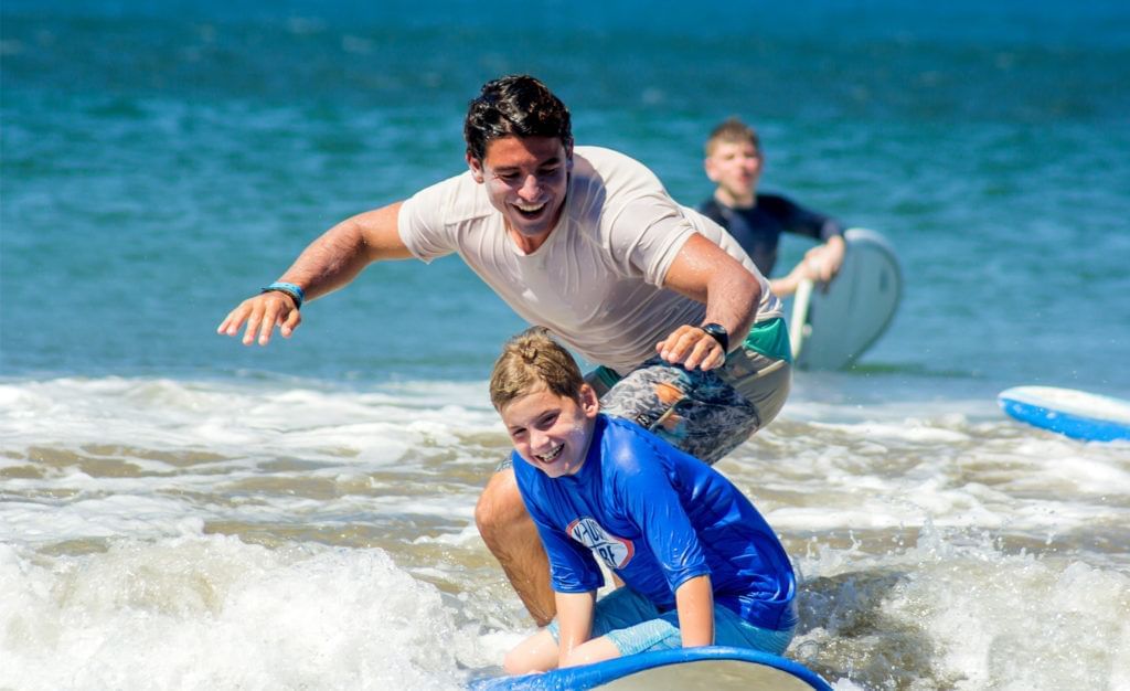 dad and son surfing in costa rica