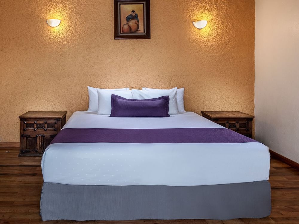 Nightstands by the bed in Deluxe Room 1 king at Gamma Hotels