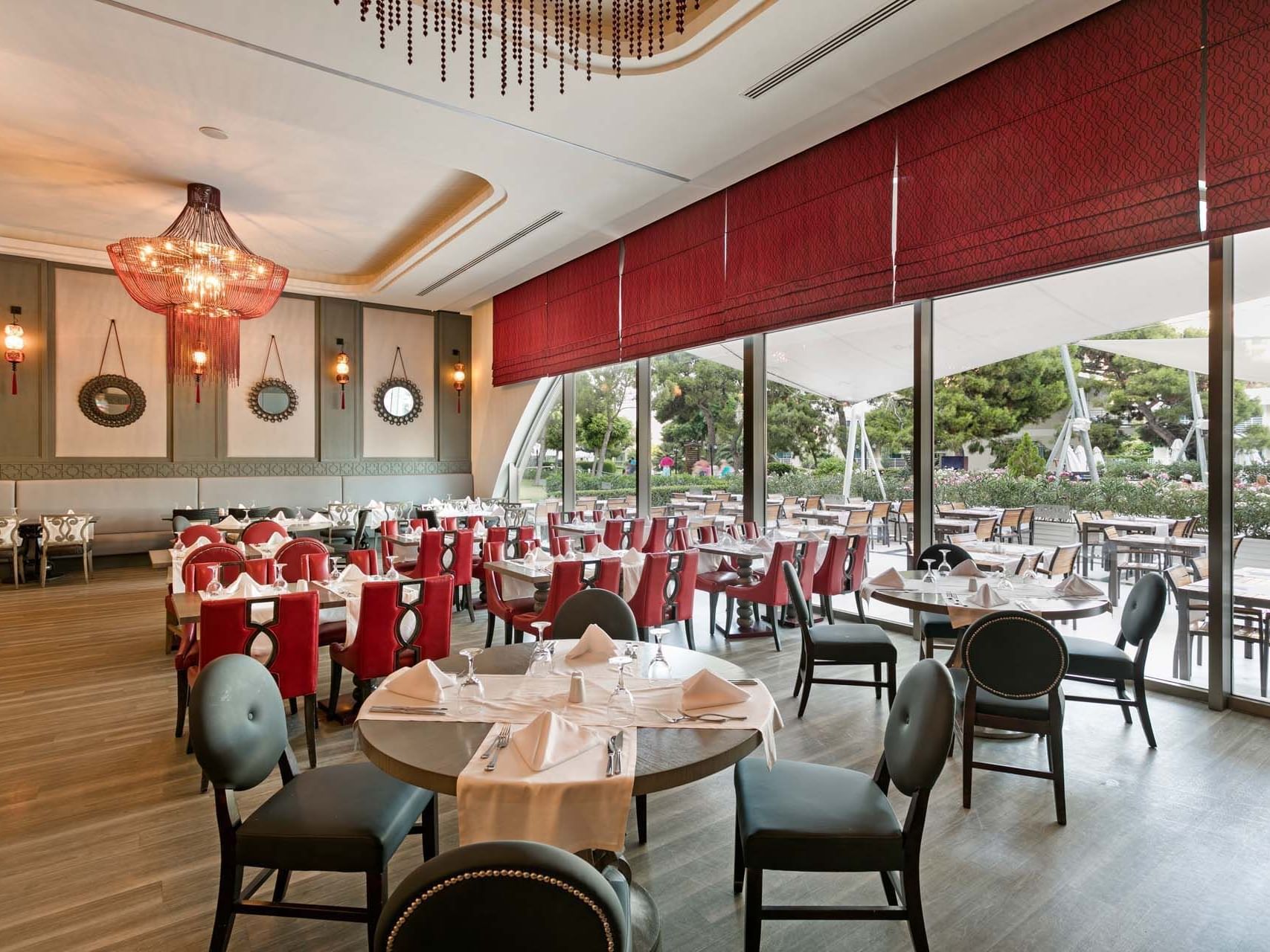 Interior of dining area with tables and chairs in Parkfora Main Restaurant at Titanic Deluxe Lara