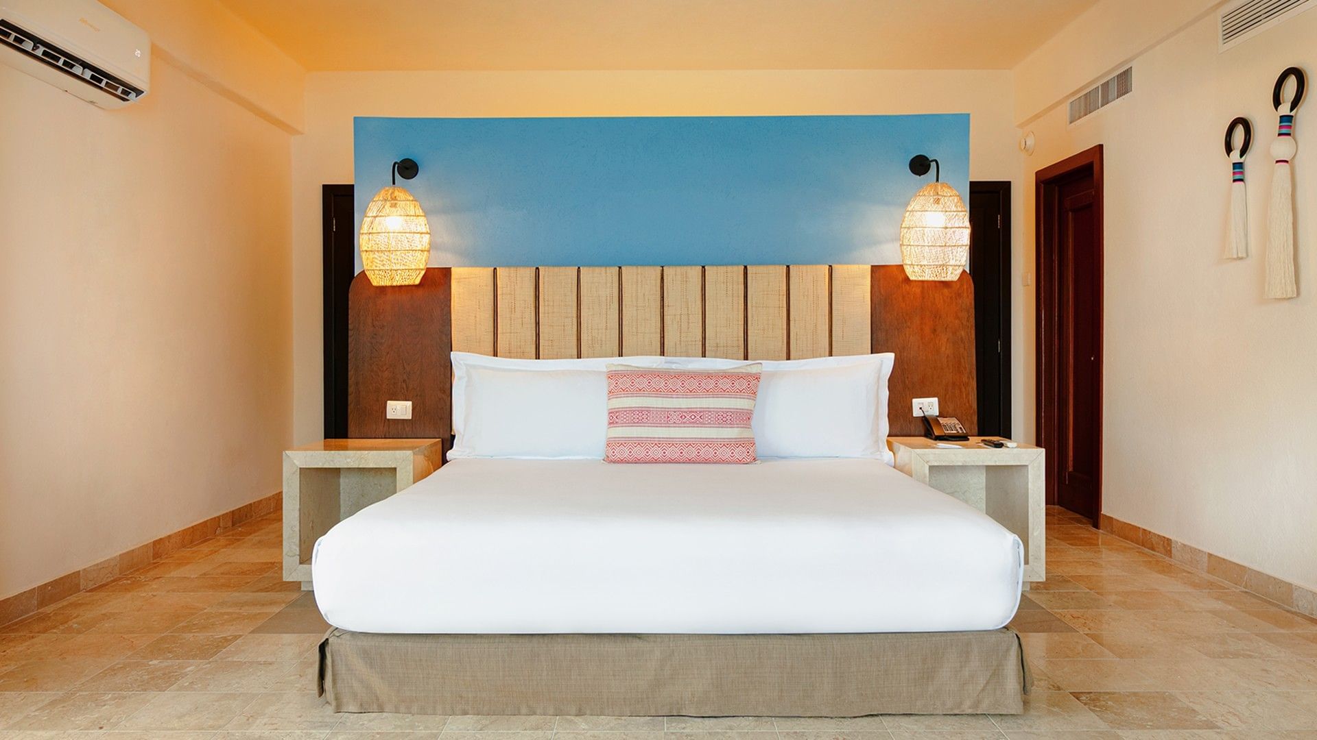 Nightstands by the bed with a cushioned headboard in King Master Suite at Camino Real Acapulco Diamante