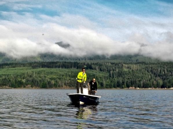 2 men on a boat in the canal at Alderbrook Resort & Spa