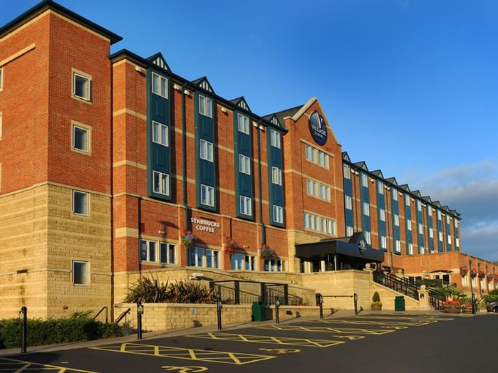 An exterior view of the hotel & car park at Village Hotels