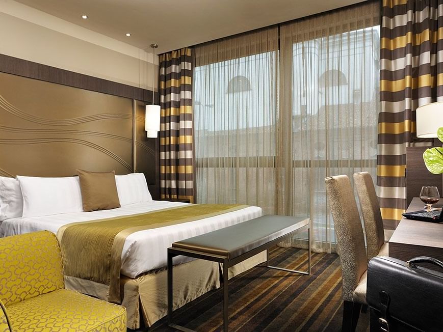 Bed & furniture in Superior King Room at Uptown Palace in Milan