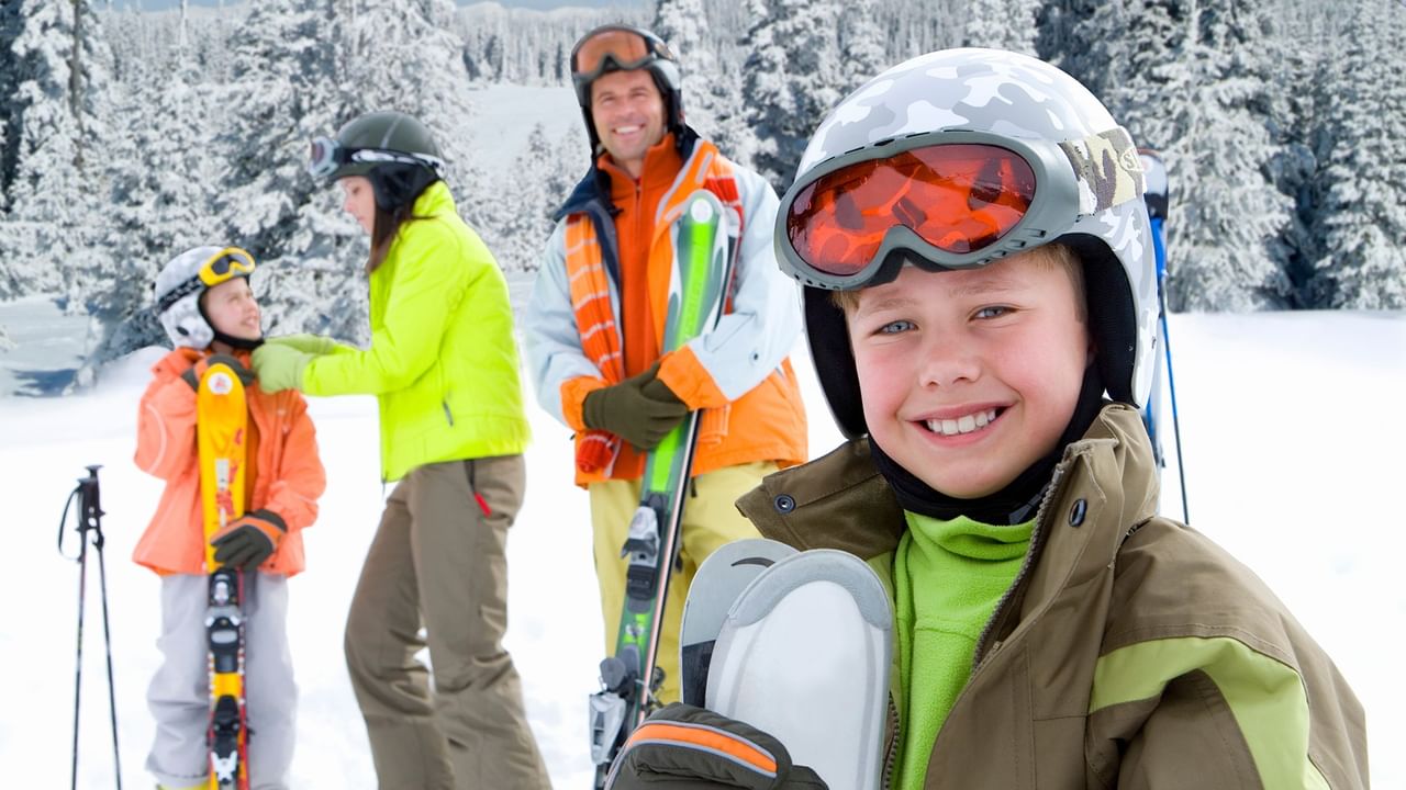 Family enjoying skiing in snowy mountain.