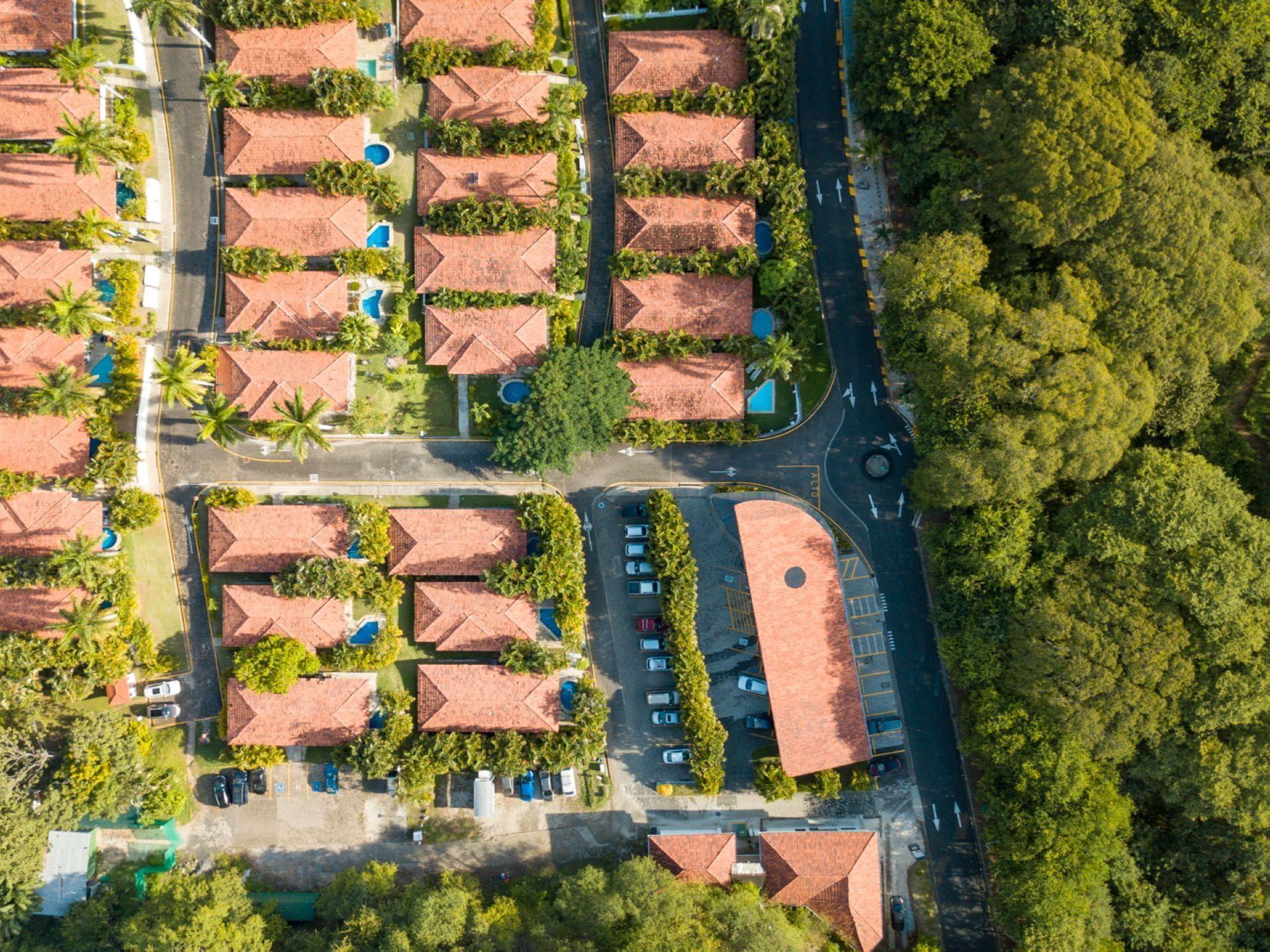 Aerial view of Villas Sol Beach Resort and the parking lot with the neighborhood