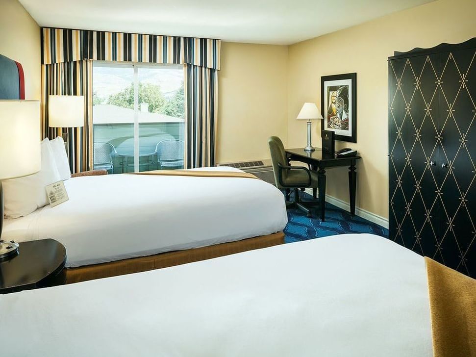 Double bed with work area in Deluxe Double Queen of Plaza Inn & Suites at Ashland Creek​