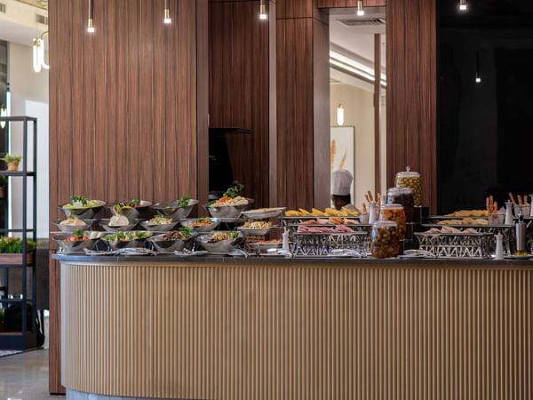 Elegant buffet area with a display of various foods at Warwick Hotel Al Jubail