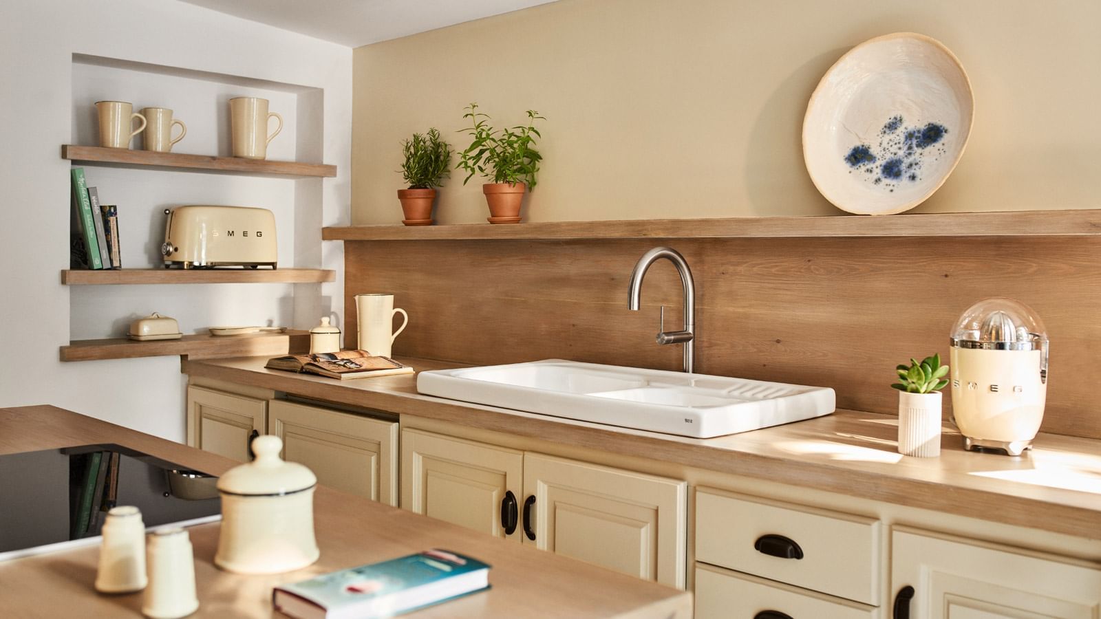 Casabel with porcelain sink, wooden shelves, beige toaster, and potted herbs at Marbella Club