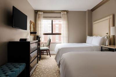TV, dresser, & work desk facing the bed in Deluxe Two Double Beds Room at Hotel Bijou, featuring San Francisco accommodation
