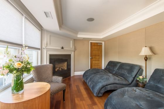 Indoor lounge area by a fireplace at The Breakwater Inn & Spa
