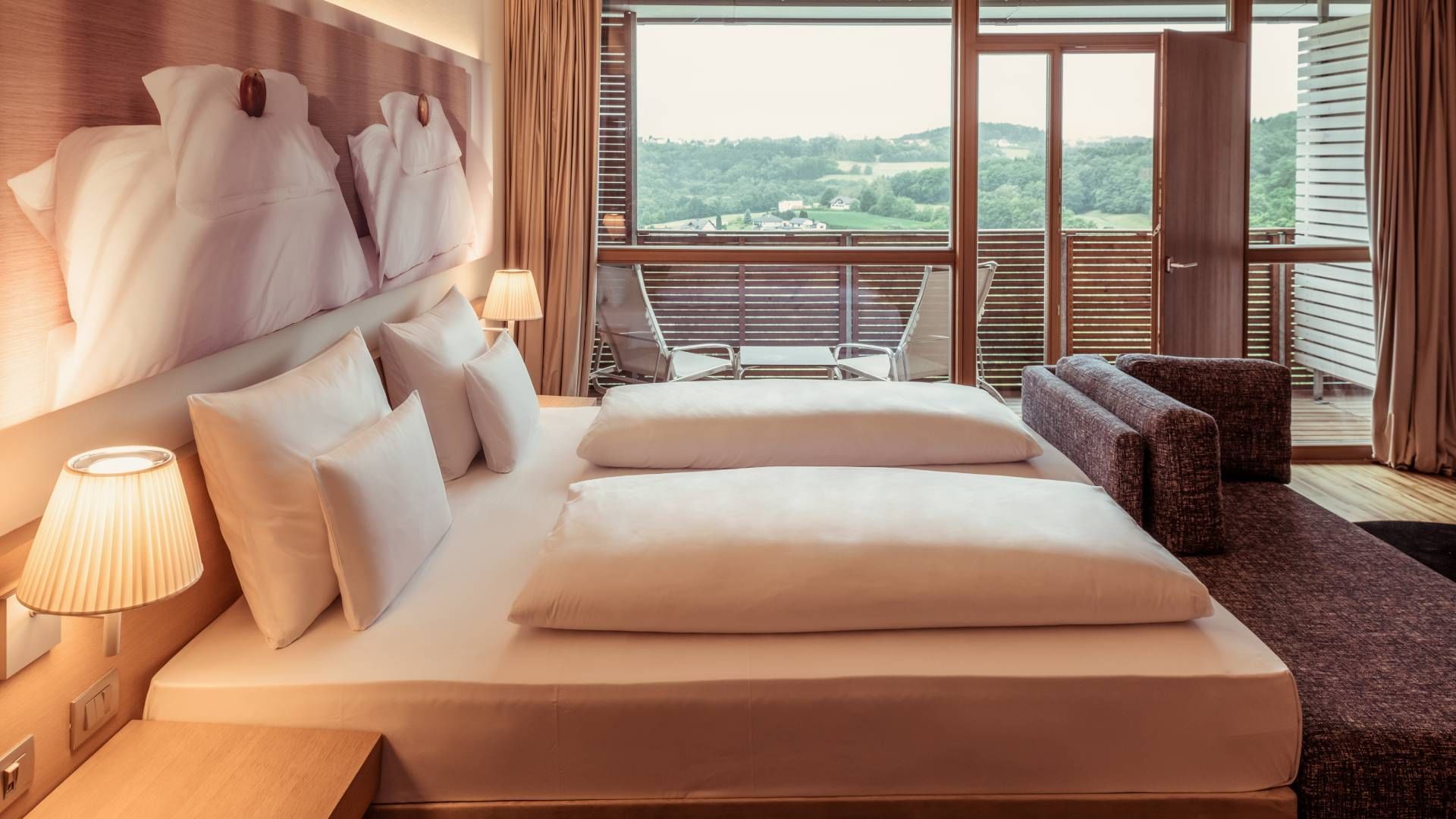 Bed & balcony in Deluxe Room at Falkensteiner Balance Resort