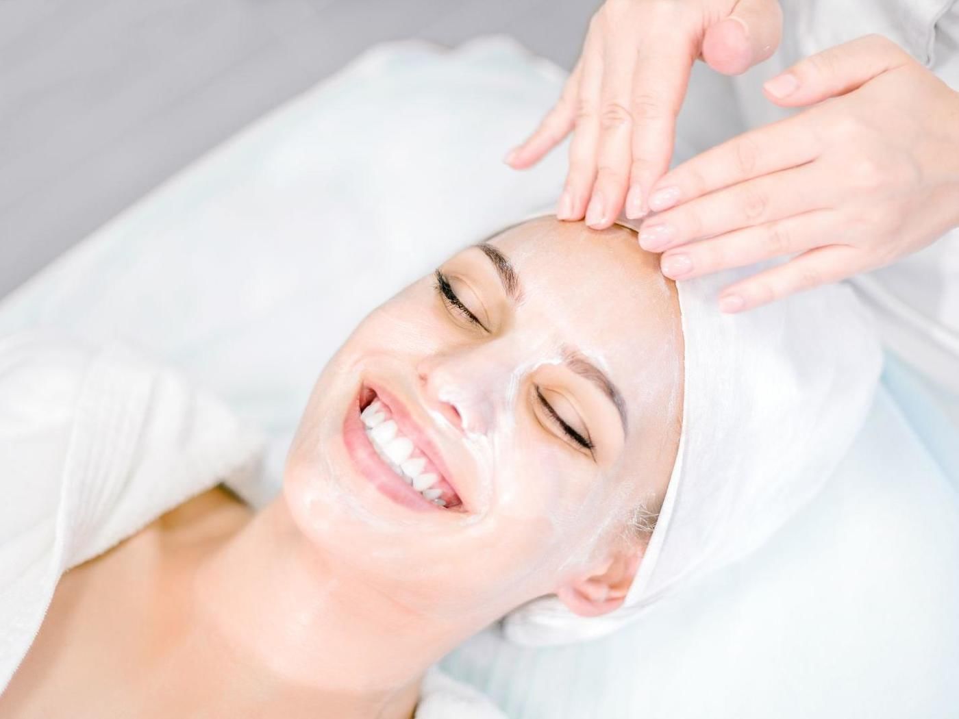 A woman getting facial treatments at FA Hotels & Resorts