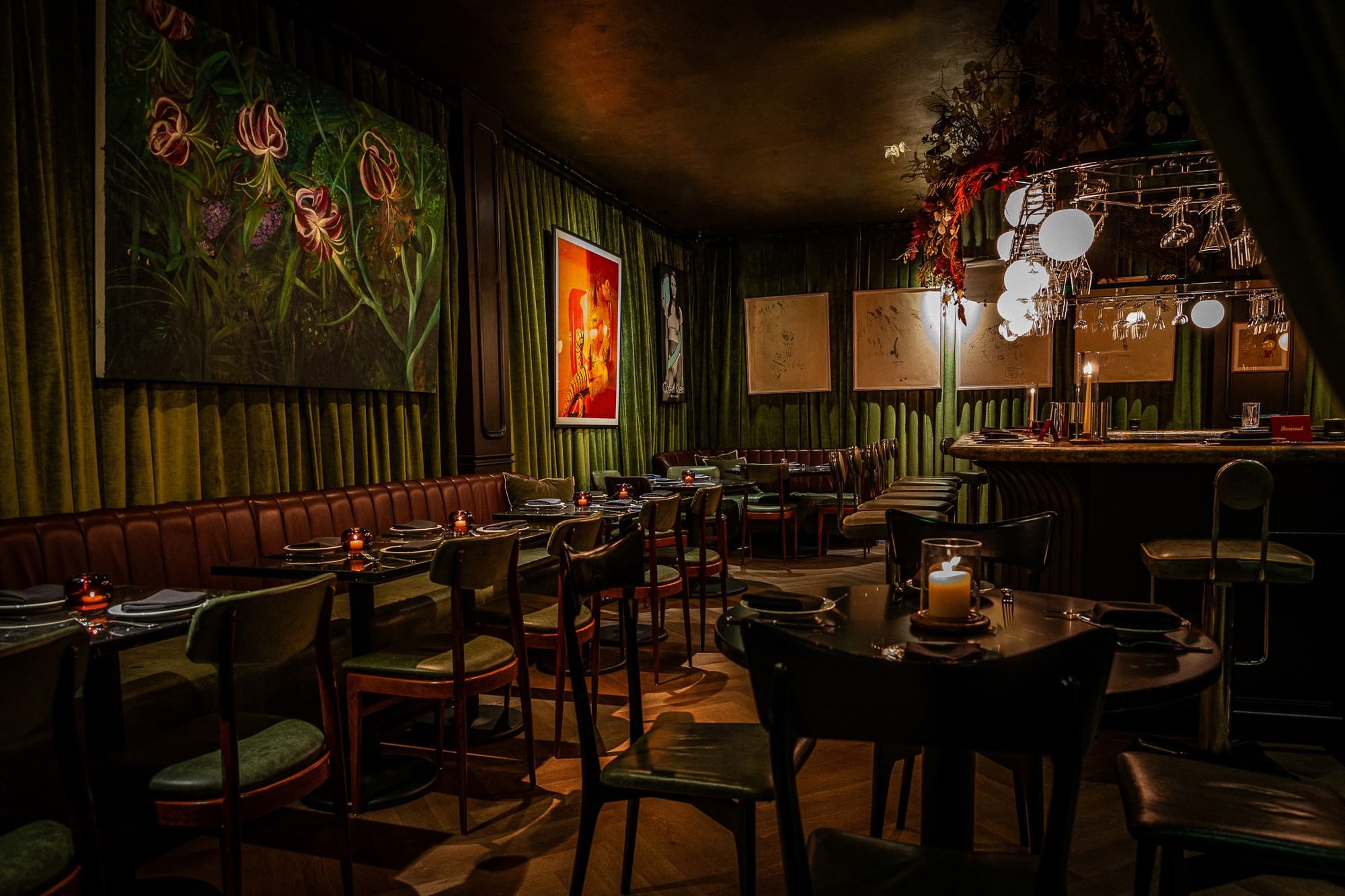 a dimly lit dining room with tables set for dinner
