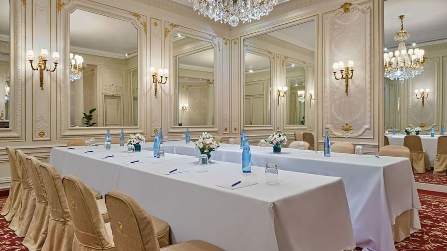 U-shaped table setup beneath crystal chandeliers in Capucines Meeting Room at Hotel Westminster Paris