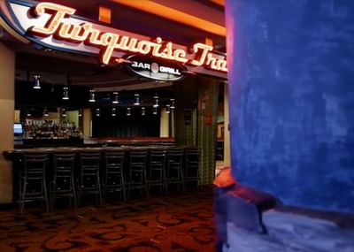 Elegant Turquoise Trail Bar and Grill at Hilton Santa Fe Buffalo Thunder, featuring a glowing neon sign