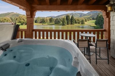 Hot tub on a wooden balcony offering a serene view in Cottage Deluxe Executive Suites at Hotel Park City Autograph Collection