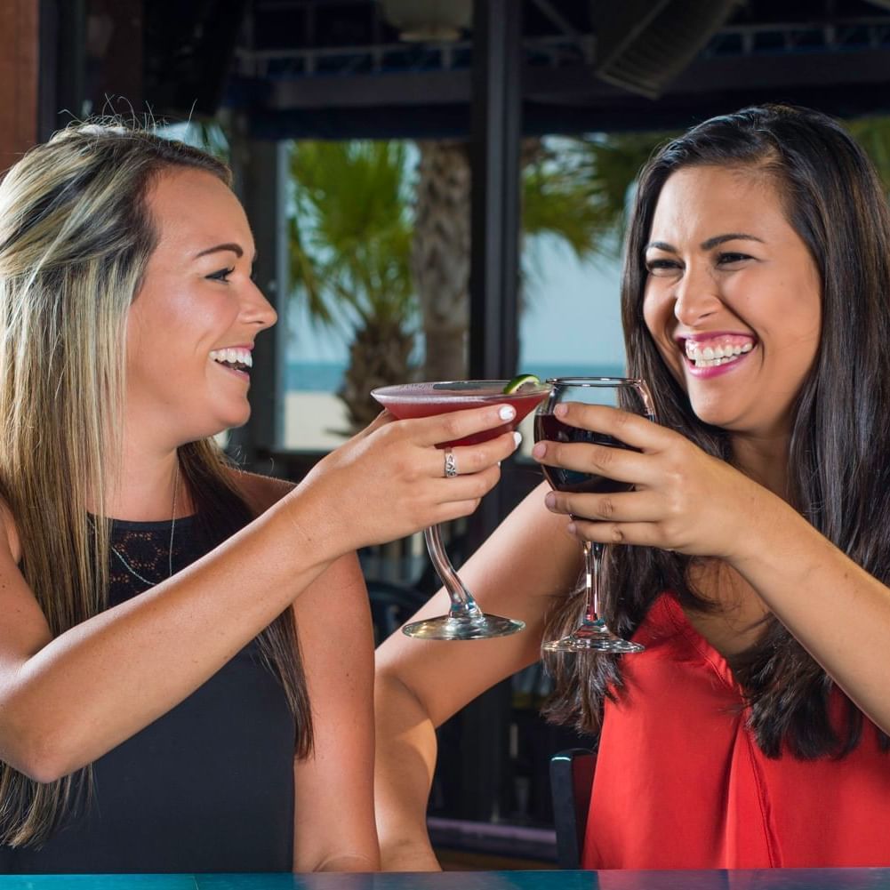 2 ladies toasting wine at Bilmar Beach Resort
