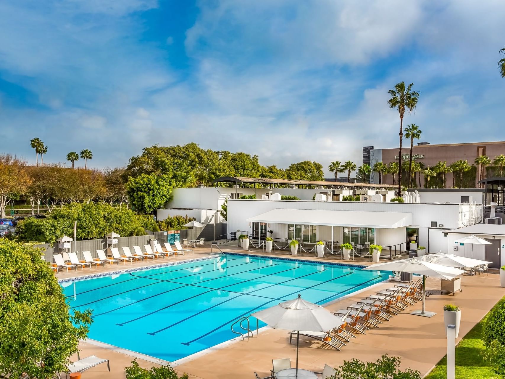 View of an outdoor pool & poolside dining area at Anaheim Hotel