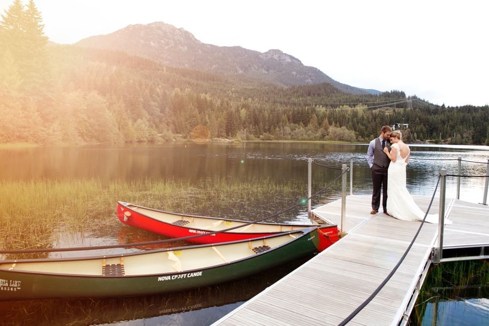 Bride & Groom posing by the lake at Nita Lake Lodge