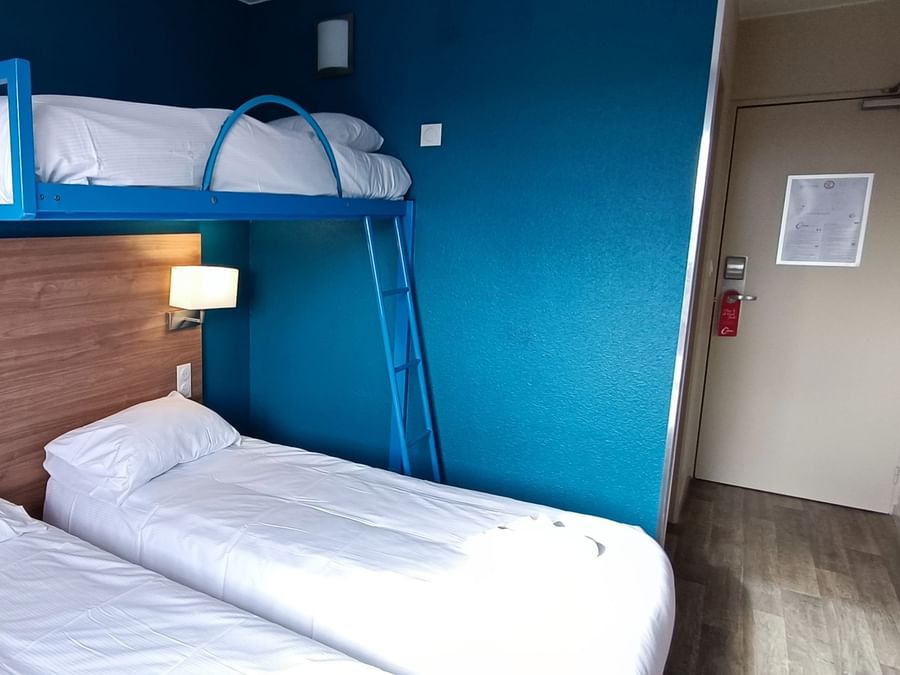 2-single beds with a bunk bed in a room at The Originals Hotels