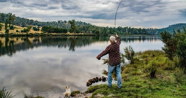 Man enjoys fishing on the edge of the river