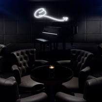 Seating set-up in dark light at Q's Bar of Palazzo Versace