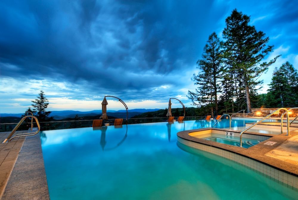 Outdoor infinity pool at dawn with surroundings in Stein Eriksen Residences