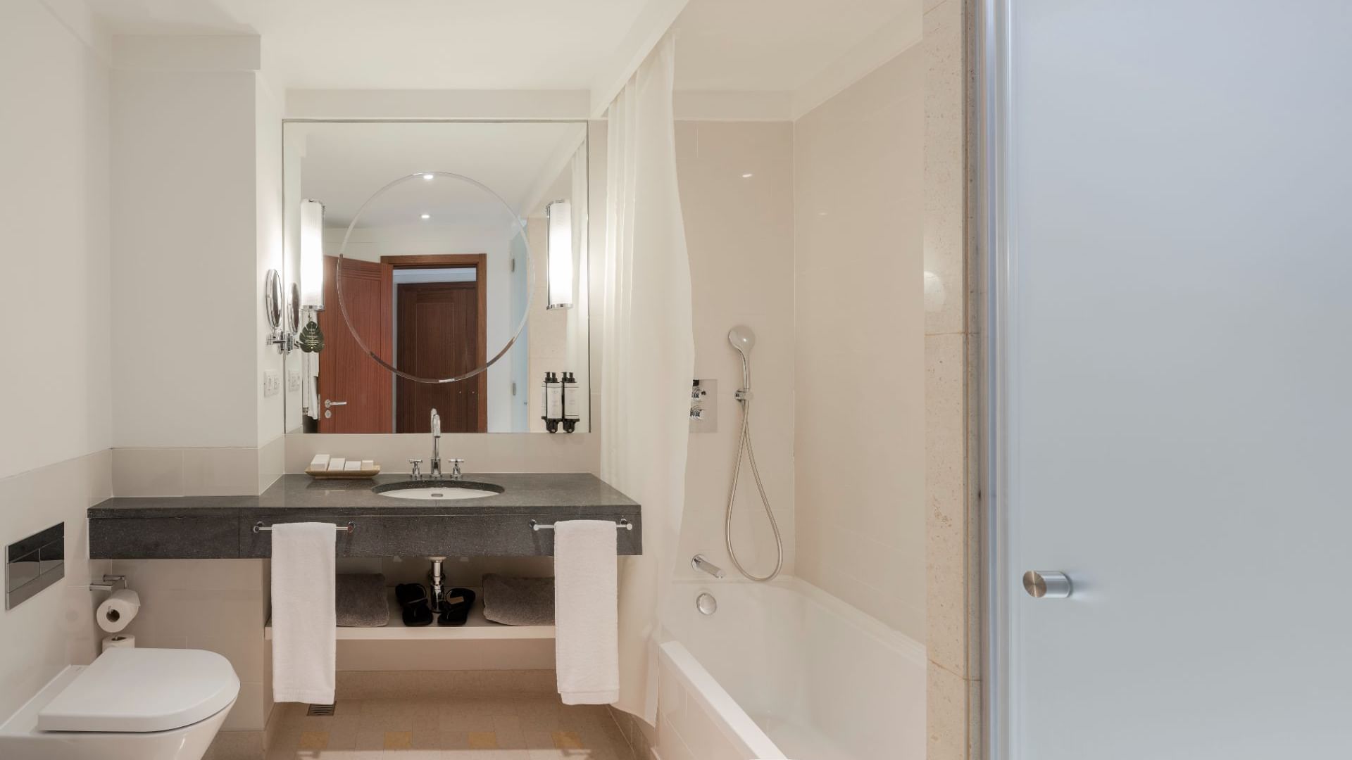 Bathroom vanity, mirror, amenities, towel rack & bathtub in Superior Garden View Room at Terra Nostra Garden Hotel
