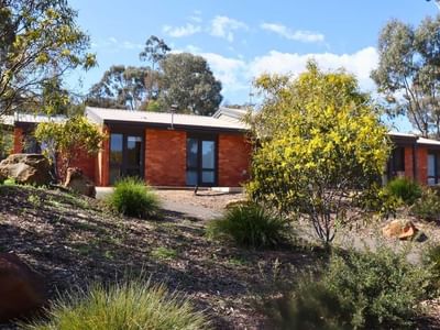 A modern house surrounded by greenery and trees at La Trobe University Terraces.