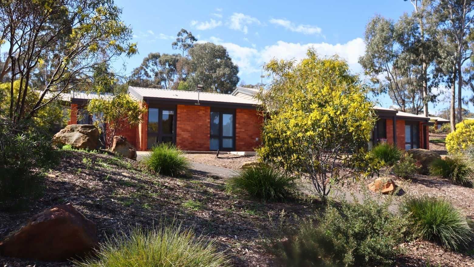 A modern house surrounded by greenery and trees at La Trobe University Terraces.