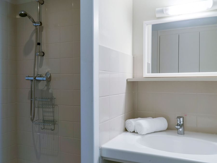 Bathroom shower & vanity area in a room at Hotel de la Mer