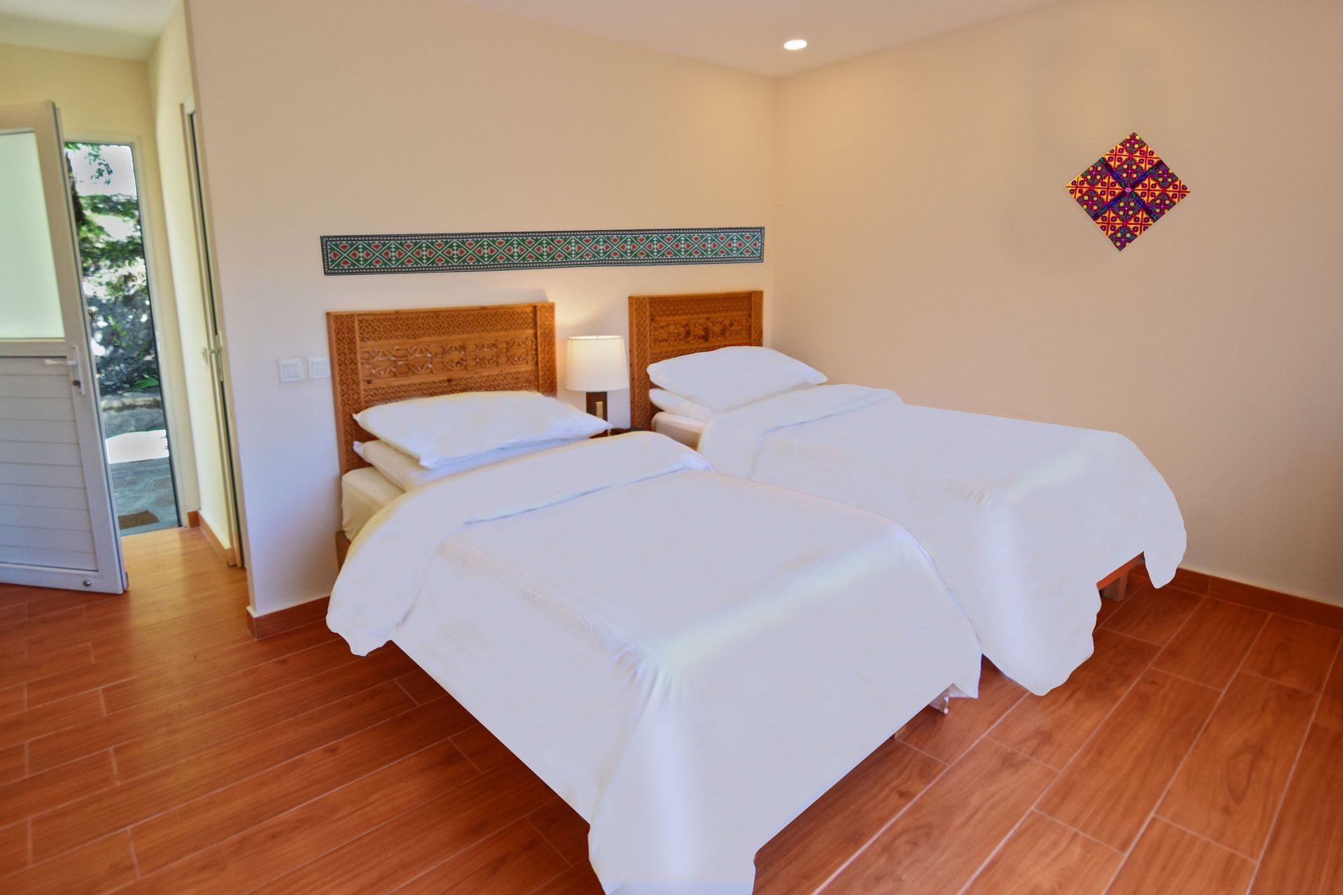Interior of a hut with twin beds at Serena Altit Fort