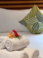 Towels and flowers on a bed in Warwick Deluxe Rooms at Warwick Fiji Resort and Spa, Korolevu.