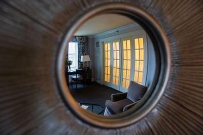 Close-up on a mirror reflection of a bedroom at The Eliot Hotel