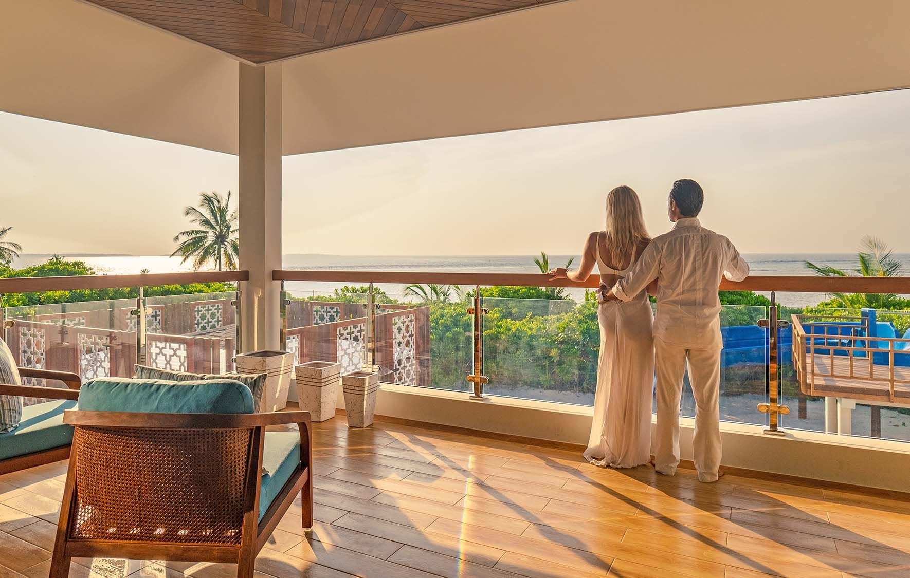 Couple relaxing on a balcony at The Signature Collection
