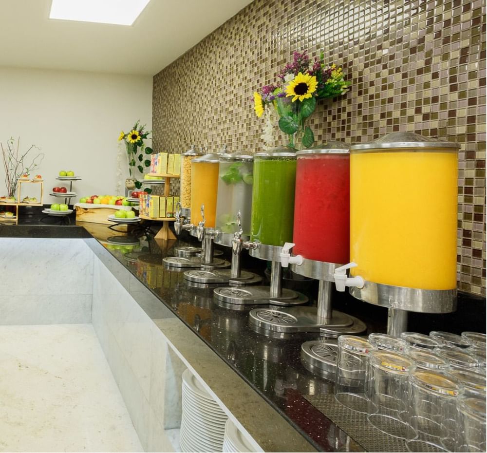 Colorful beverages and food items on display at the buffet area in Real Inn Tijuana