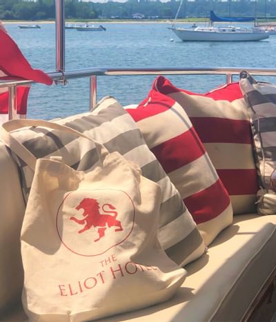 Close-up of a boat toat with Eliot Hotel's sign on a boat couch