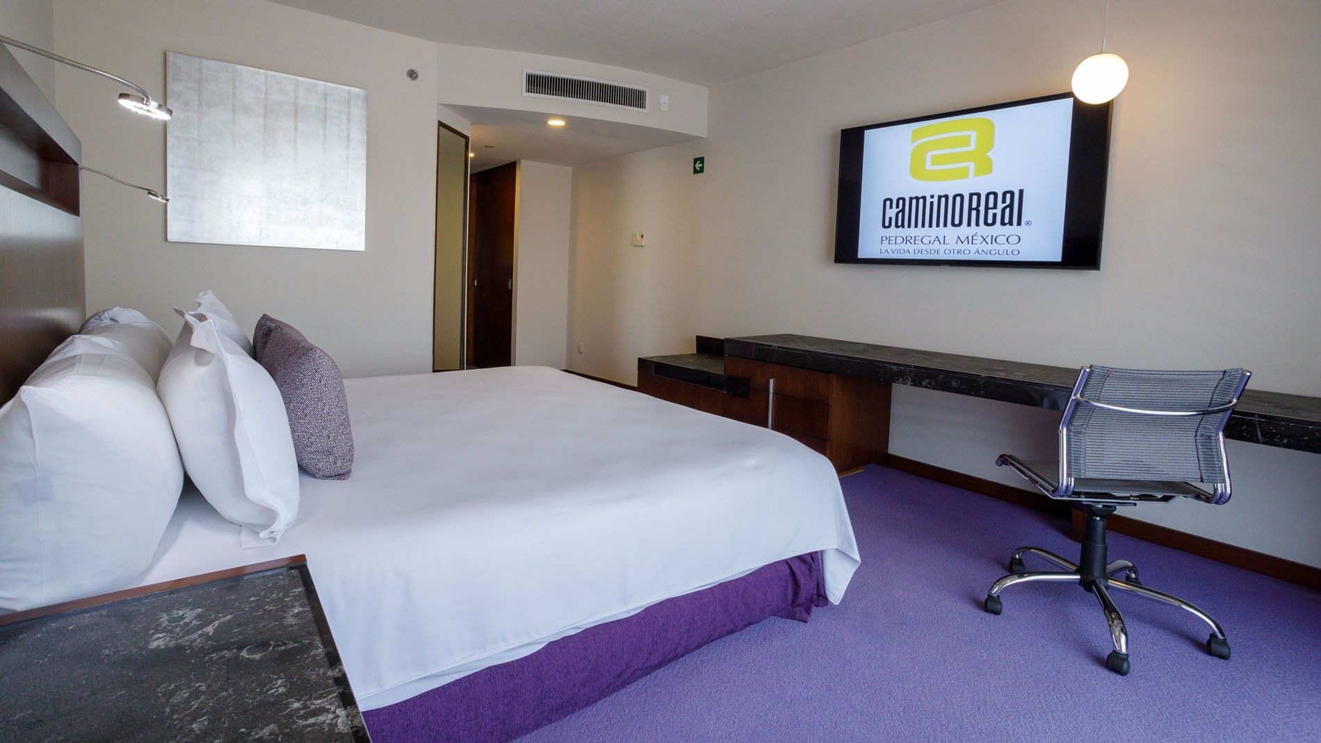 King Camino Real Club at Camino Real Pedregal Mexico, showing a branded TV screen, work area, and purple carpeting