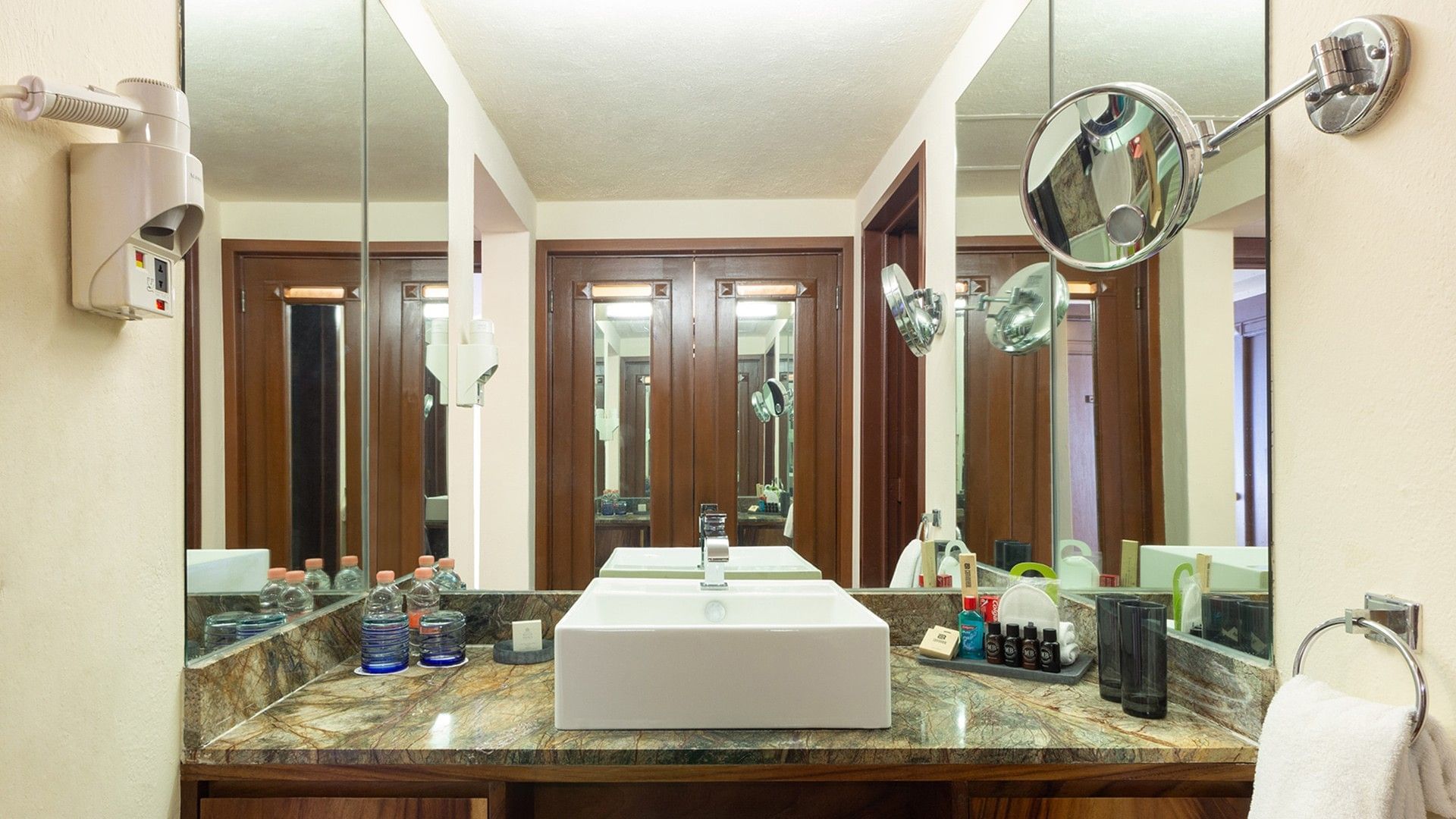 Symmetrical bathroom vanity with square sink, mirrors, and toiletries in King Master Suite at Camino Real Acapulco Diamante